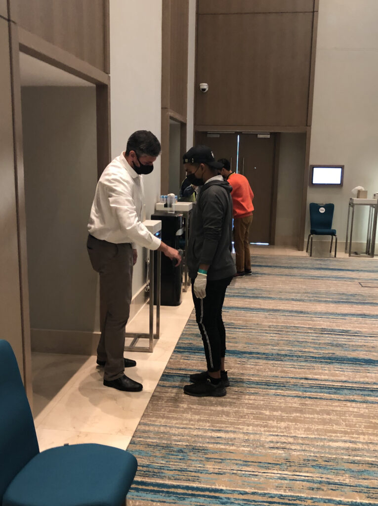Attendee being scanned at an event by security guard