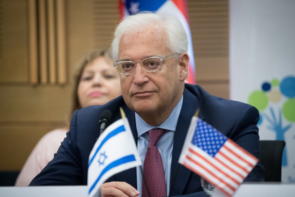 Profile shot of David Friedman with Israeli and US flags at press conference